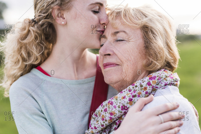 Granddaughter kissing her grandmother