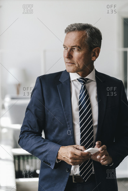 Portrait of mature businessman with cell phone