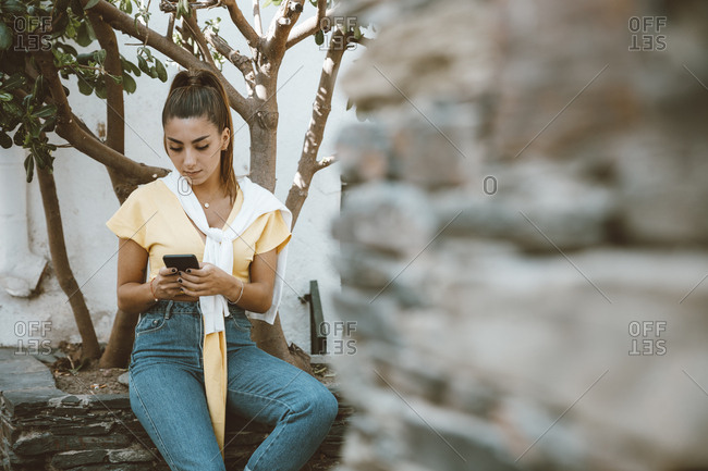 Young girl writing a message while waiting for an appointment