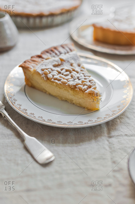 Slice of custard pie with pine nuts
