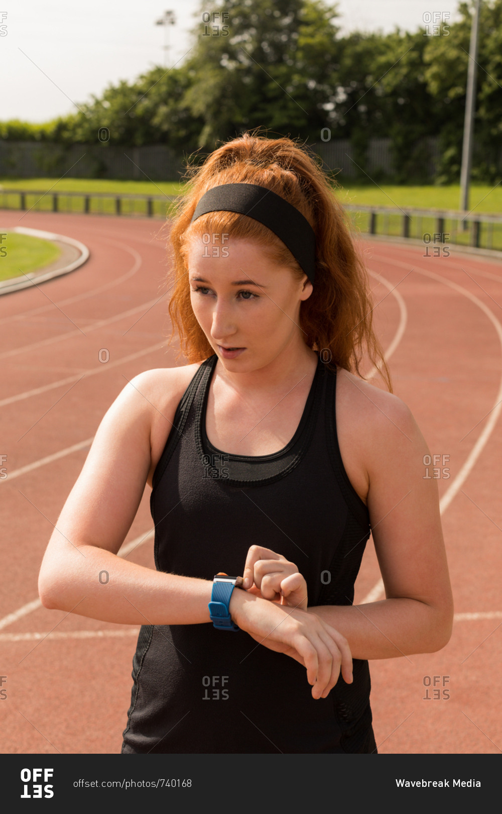 Young male athletic using smart watch on running track