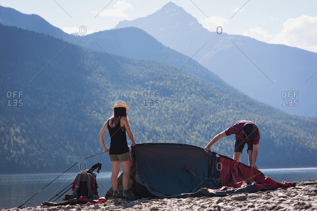 Couple making preparation for setting up a tent on a sunny day