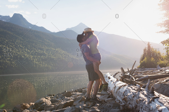 Couple kissing each other near riverside at countryside