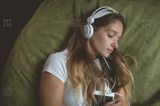 Woman listening music on headphones 