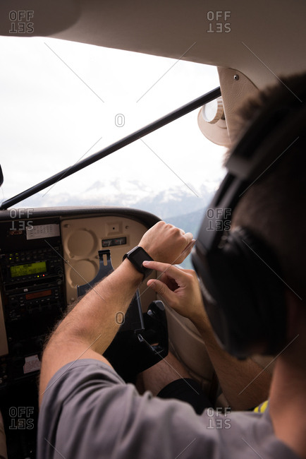 Pilot using smart watch while flying in aircraft cockpit
