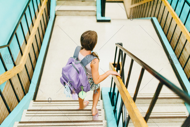 Girl walking down school staircase