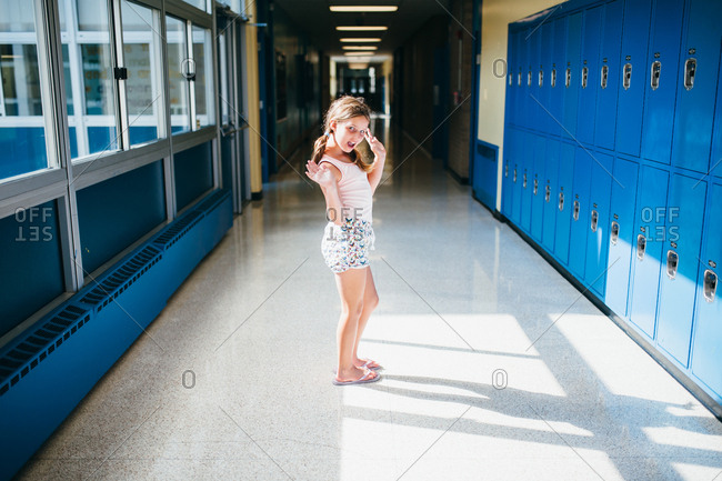 Girl in silly pose in school hallway