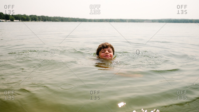 Boy swimming keeping his head above water