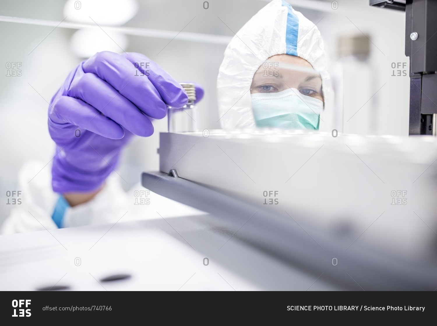 Technician checking stem cell cultures in a laboratory that manufactures human tissues for implants. Such implants include bone and skin grafts.