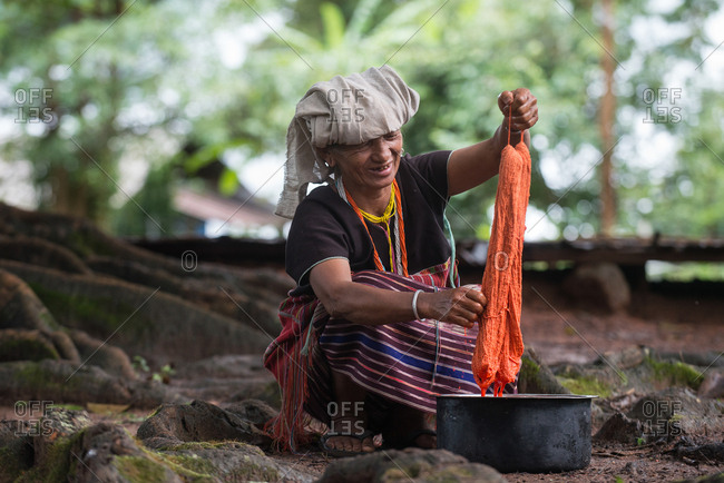 August 18, 2018: Asian Karen Hill Tribe Woman Dyeing Fabric. Chiang Mai,  Thailand.