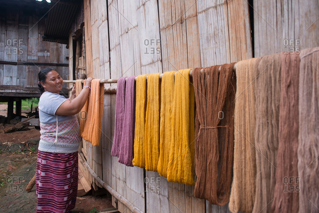 August 19, 2018: Asian Karen Hilltribe Woman Drying Dyed Fabric. Chiang Mai, Thailand.