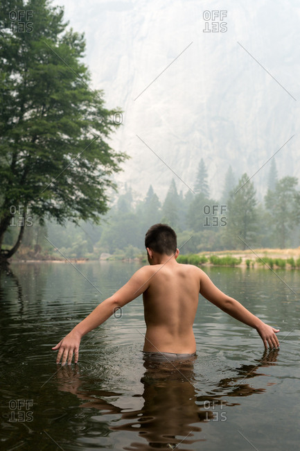 boy swimming in lake
