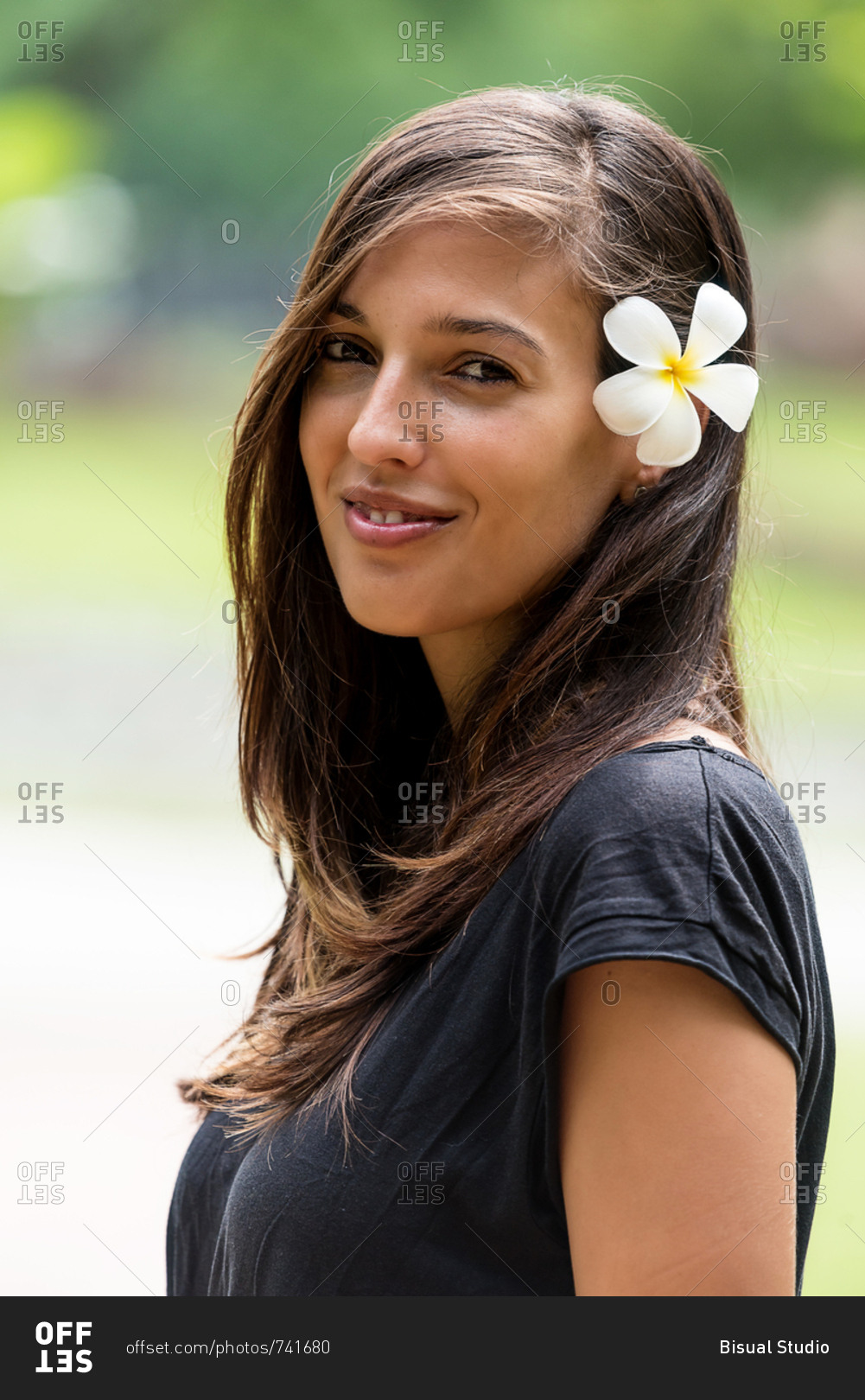 Portrait of a beautiful female with a flower on her hair in Sukhothai,  Thailand stock photo - OFFSET