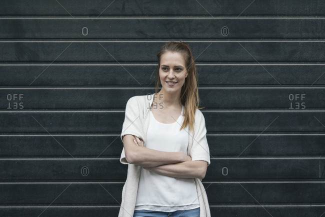 Portrait of a pretty woman in front of roller shutter