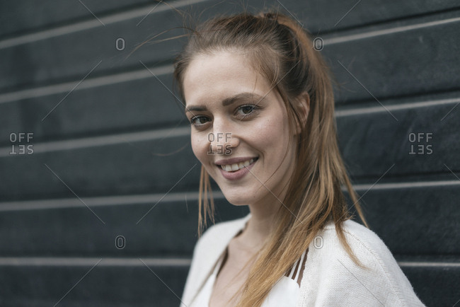 Portrait of a pretty woman in front of roller shutter