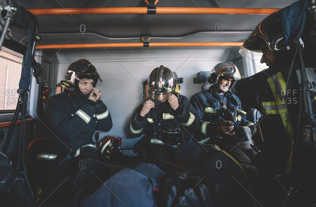 Firemen working inside an emergency vehicle.