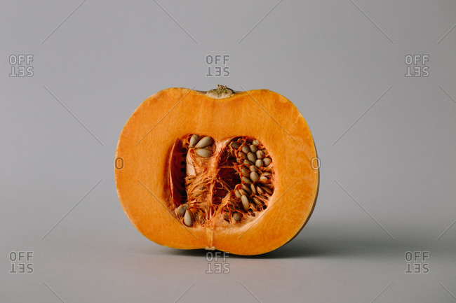 Juicy fresh half of rope bright orange pumpkin with seeds and flesh