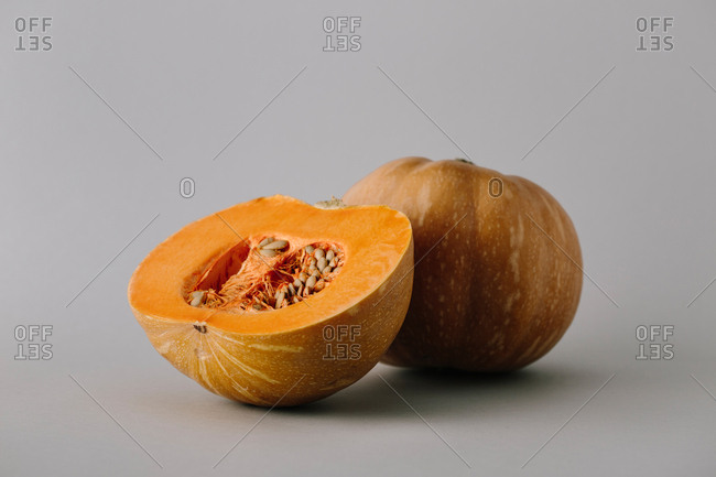 Juicy fresh half of rope bright orange pumpkin with seeds and flesh