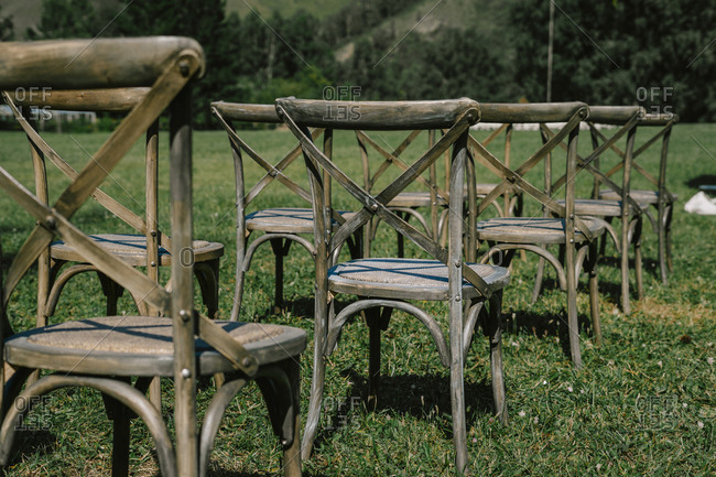 Wedding ceremony with a square arch and wooden chairs. rustic wedding in nature. mountain and forest view