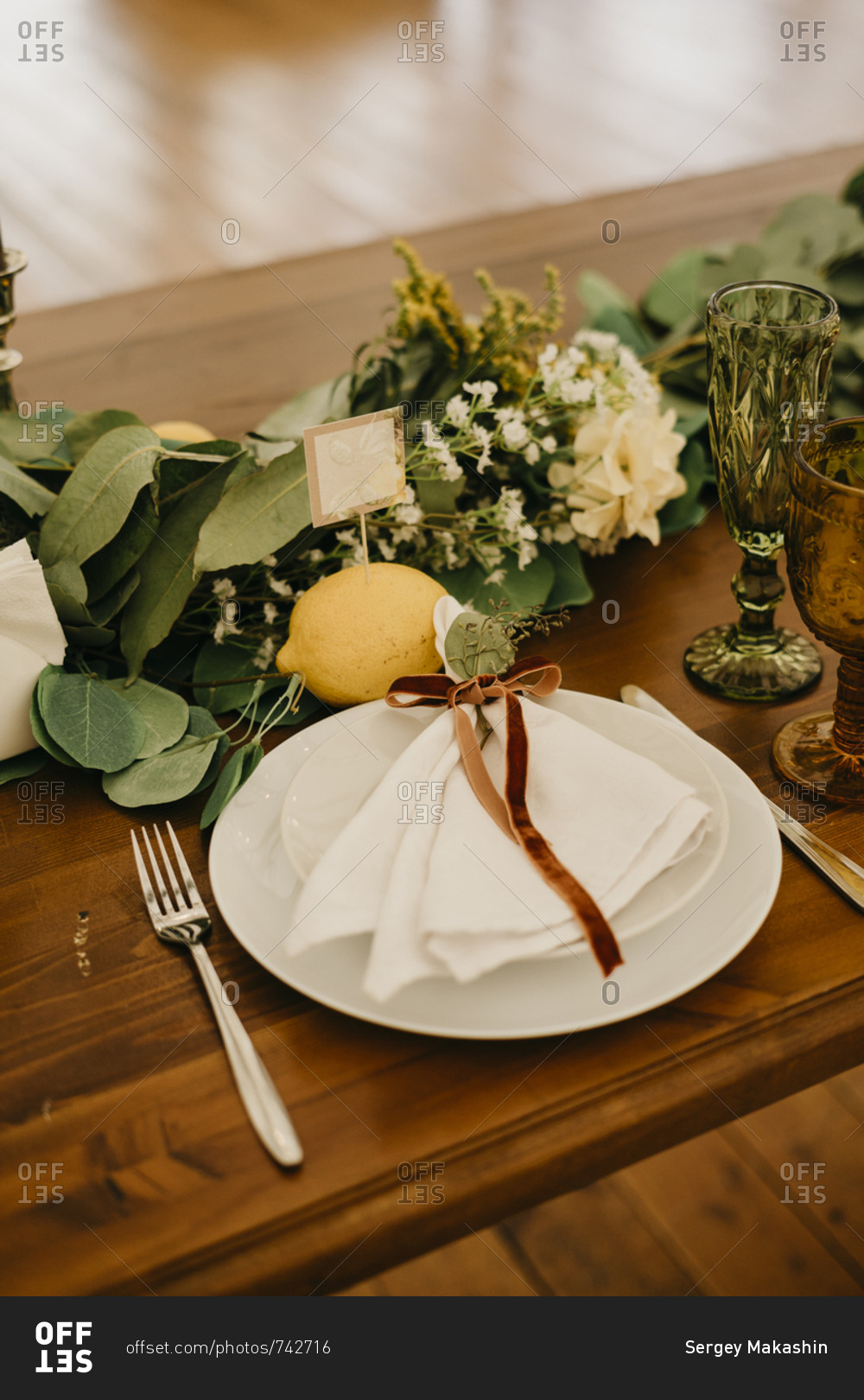 Italian wedding decor. rustic style with lemons. served table with plates and boho chic glasses