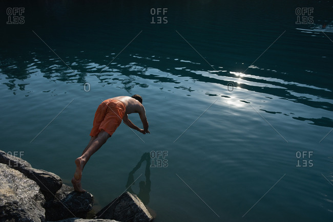 Man diving in river at countryside
