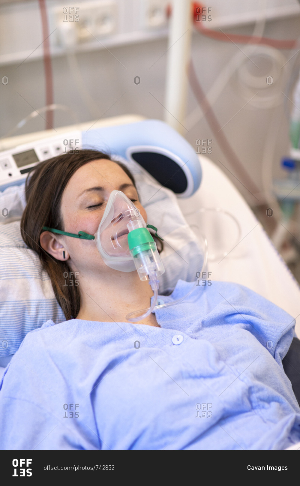 High Angle View Of Patient Wearing Oxygen Mask While Sleeping On Bed In Hospital Stock Photo