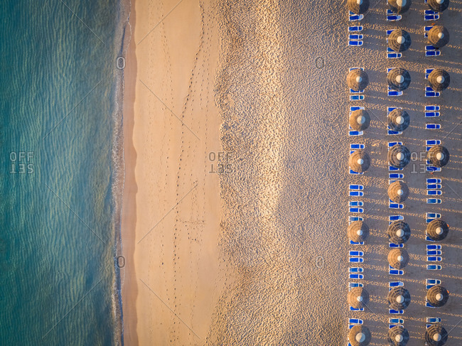 Aerial View Of Coastline Beach Deck Chairs And Umbrellas In Al