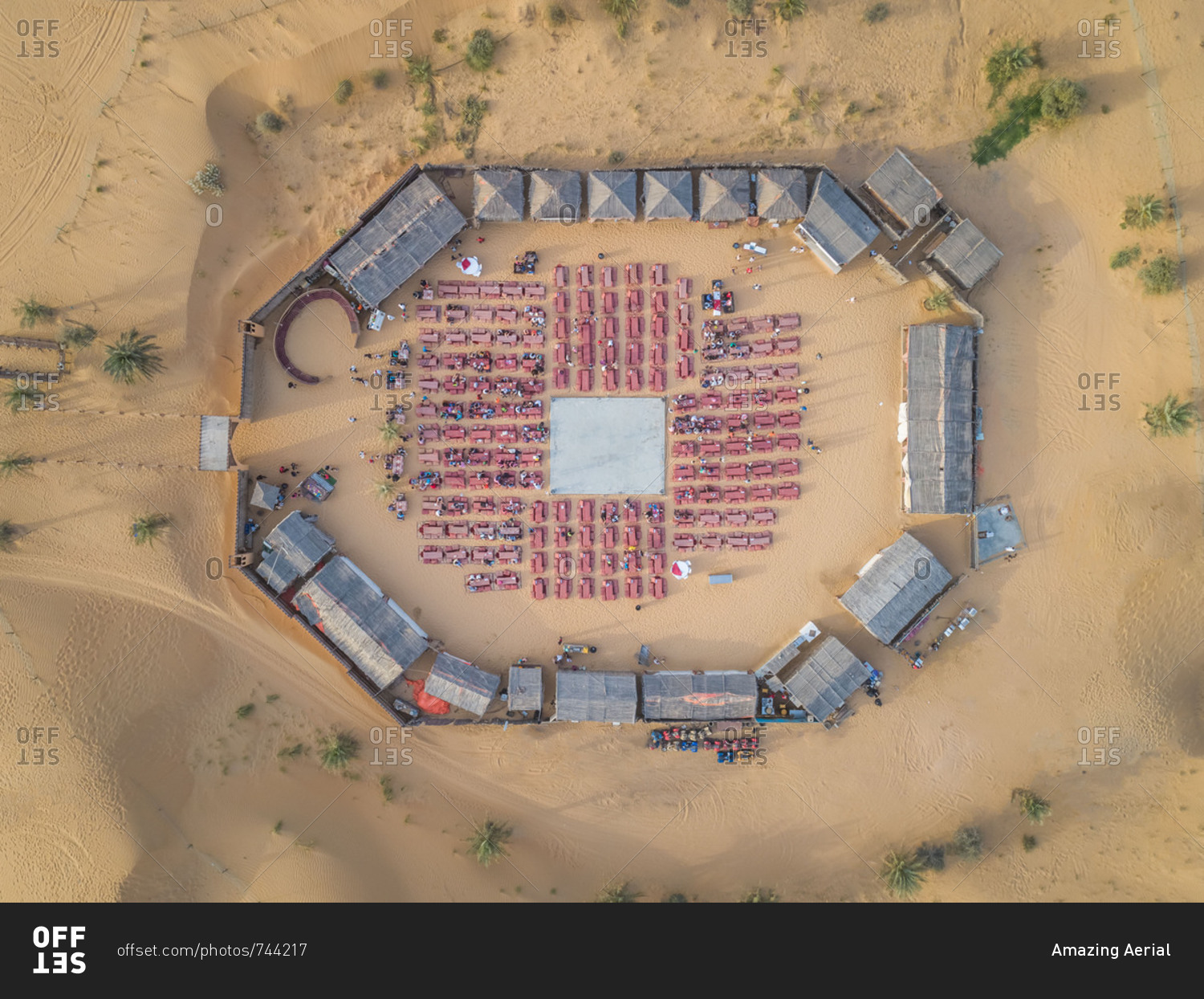 Aerial view of desert safari camp with straw roof huts, Al Awir, Dubai, UAE.