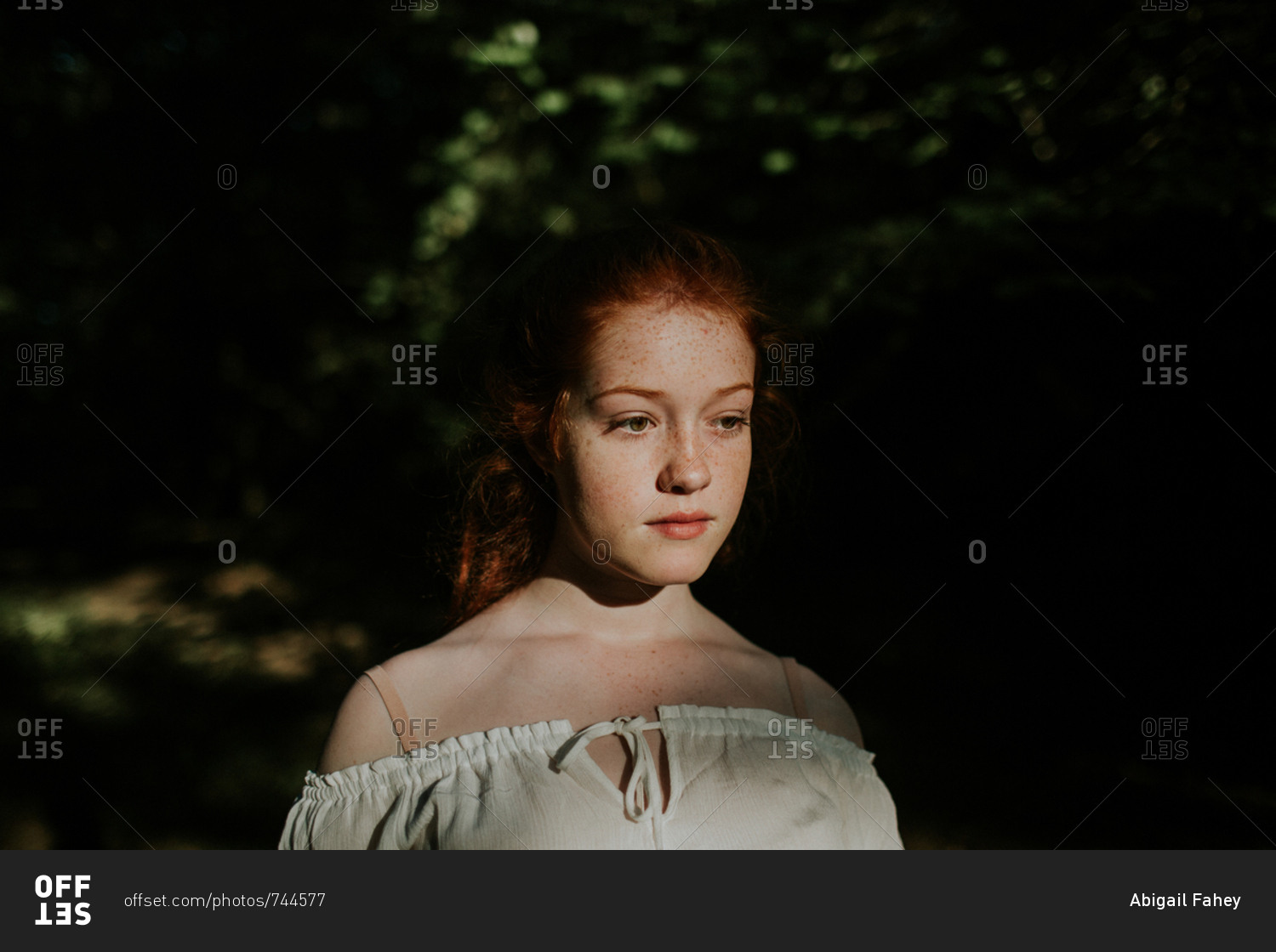 Portrait of a redheaded girl wearing off-shoulder blouse