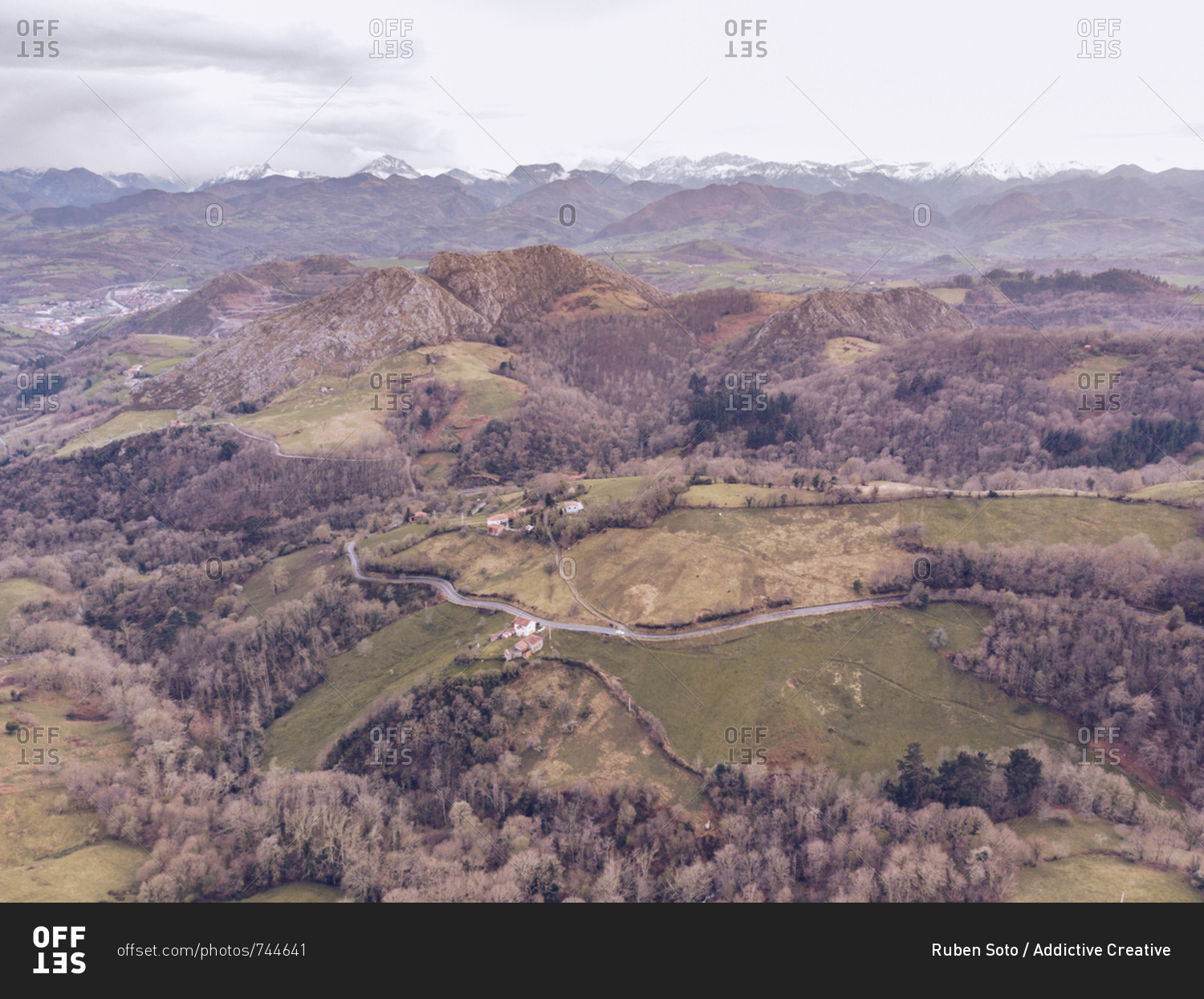 Picturesque drone view of majestic mountain ridge and hilly terrain on cloudy day in Asturias, Spain