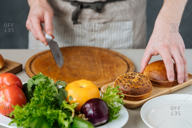 Chef cutting buns for burgers