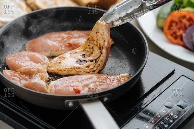 Chicken cooking in a frying pan