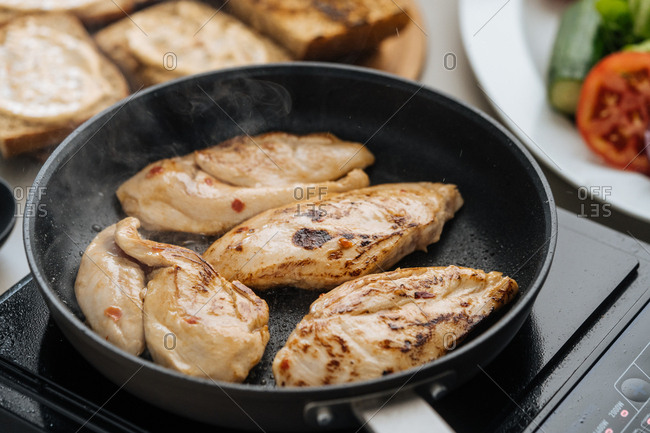 Chicken cooking on a frying pan