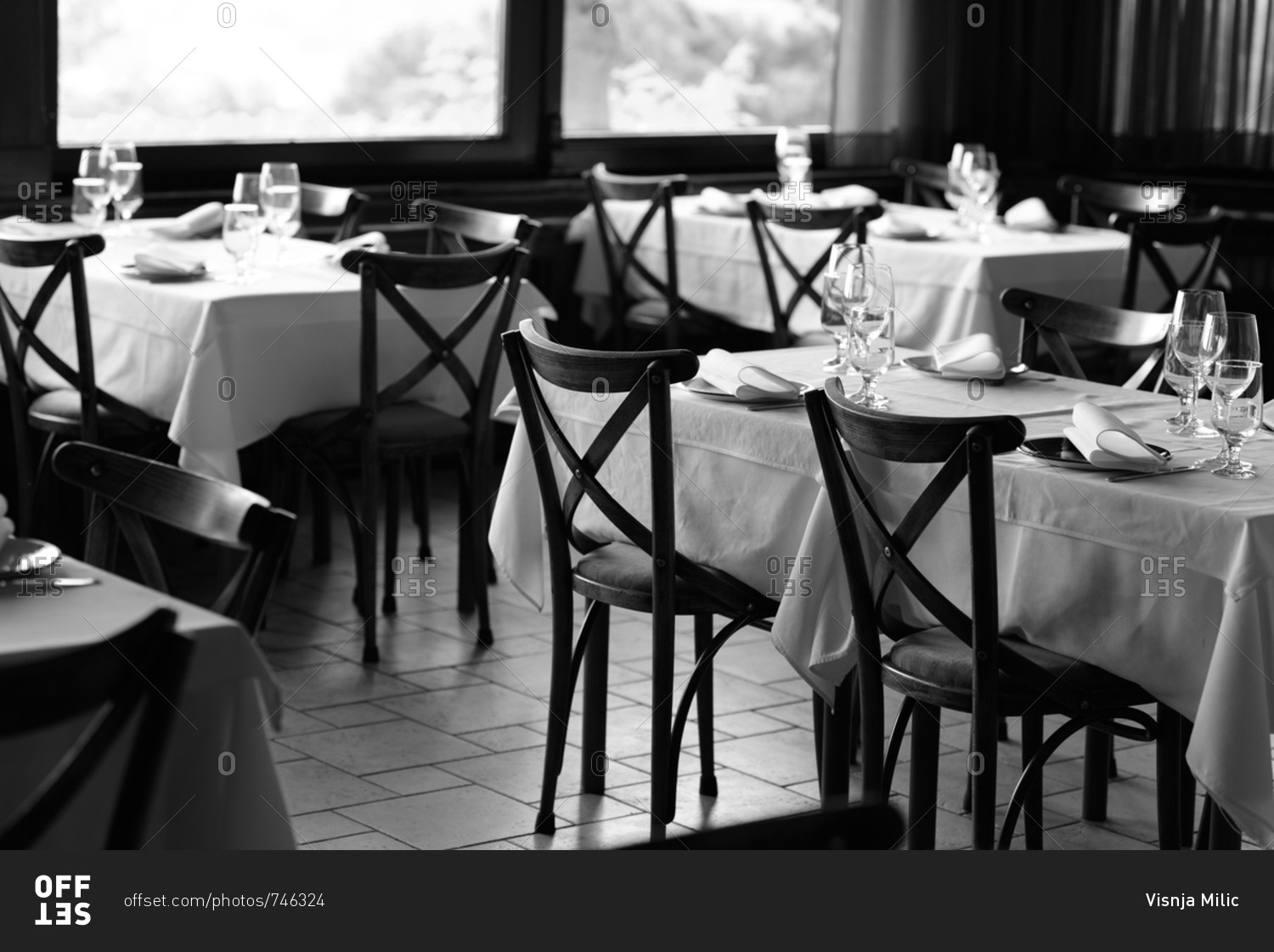 Black and white photo of restaurant interior with table settings