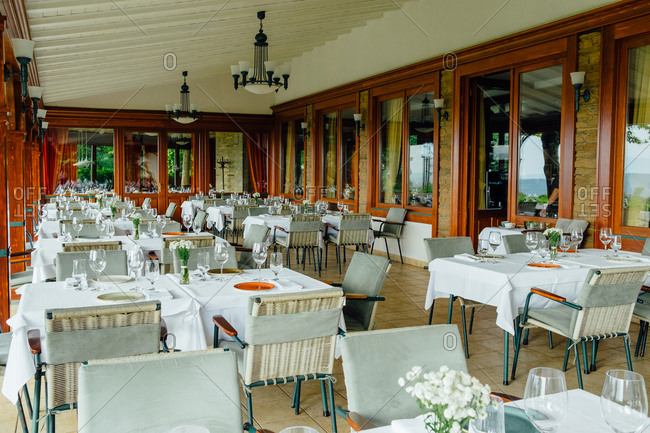 Beautiful restaurant terrace with table settings on tables