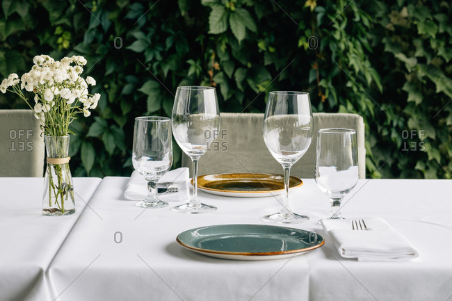 Drinking glasses and table setting on table