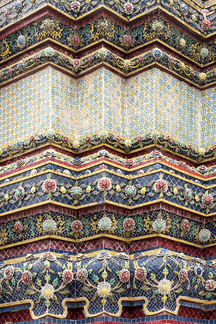 Close-up view of ornamental wall of Wat Arun temple in Bangkok with flower pattern