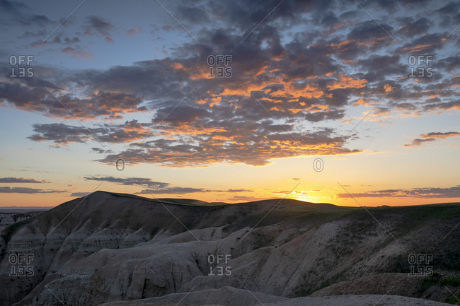 Rock formations of Badlands National Park at cloudy sunset, South Dakota, USA