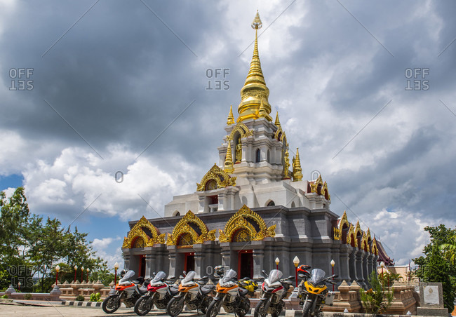 Group of motorcycles parked near stupa, Nan, Mueang Chiang Rai District, Thailand