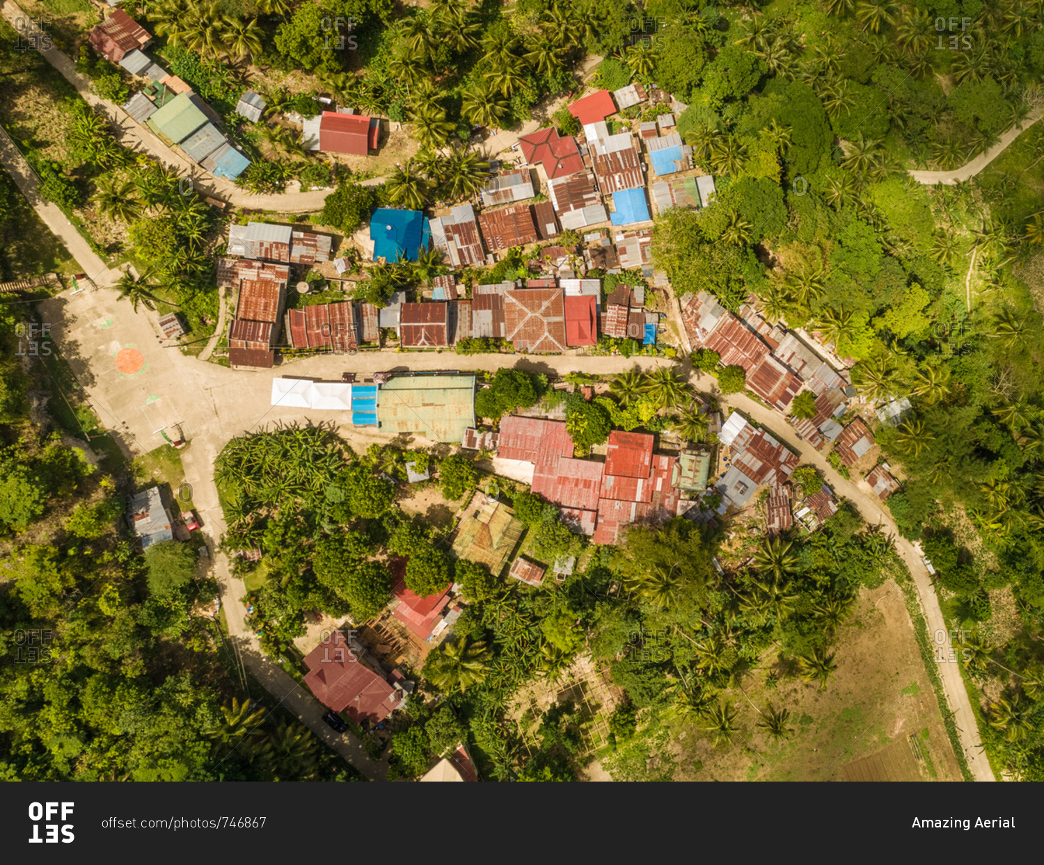 Aerial view of colorful rooftops and road in Dalaguete, Philippines.