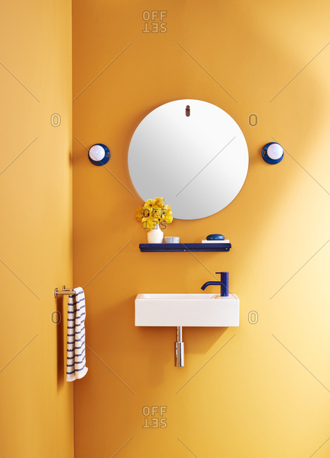 Bright orange bathroom with wall-mounted sink
