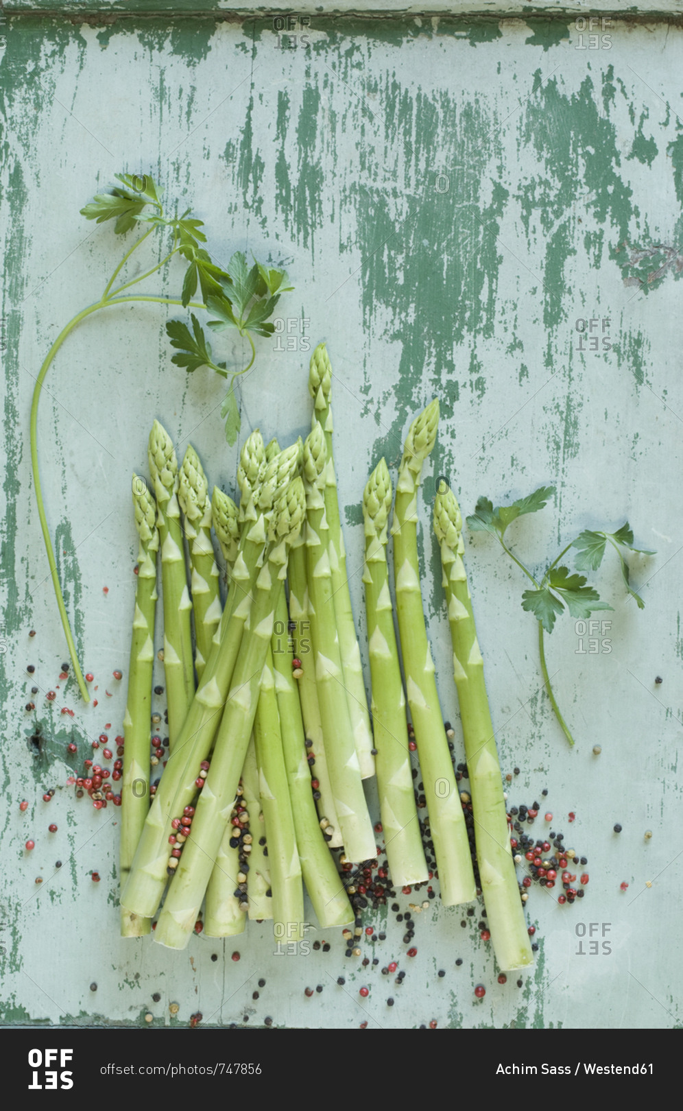 Raw green asparagus spears- parsley  and mixed peppercorns