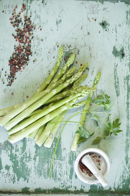 Raw white asparagus spears- parsley and mixed peppercorns