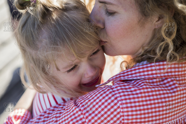 Mother consoling her crying daughter