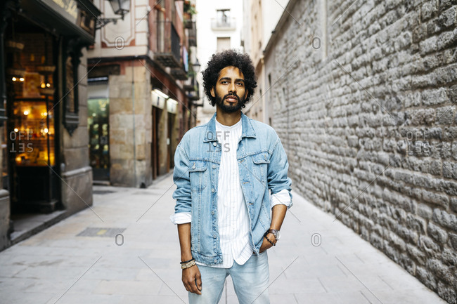 Spain- Barcelona- portrait of bearded young man with curly hair stock photo  - OFFSET