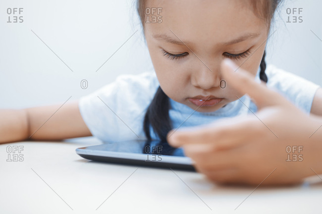 Cute girl using table computer on the table