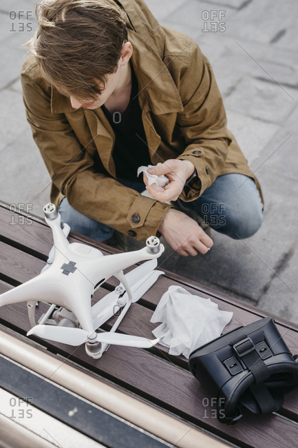 Handsome guy cleans and repairs drone before flight