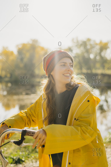 Young woman smiling while riding a bike on a sunny day