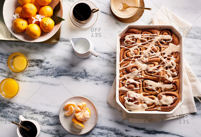 Whole-wheat cinnamon rolls with maple glaze on a breakfast countertop