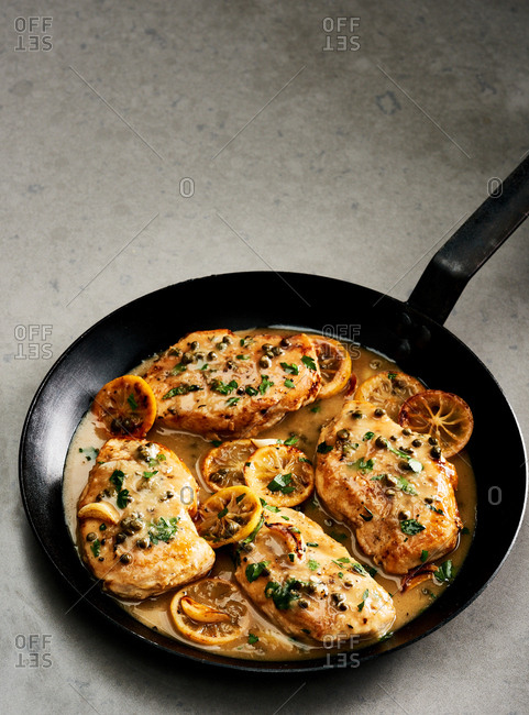 Charred lemon chicken piccata in a skillet